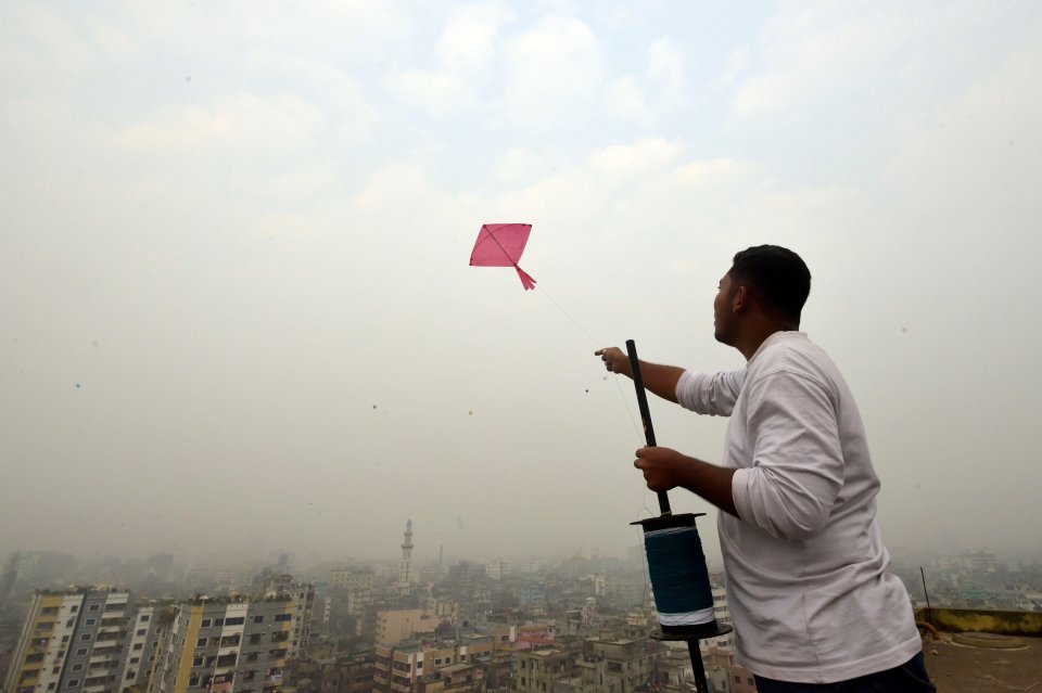 A man flies a kite during Sakrain festival in Dhaka, Bangladesh