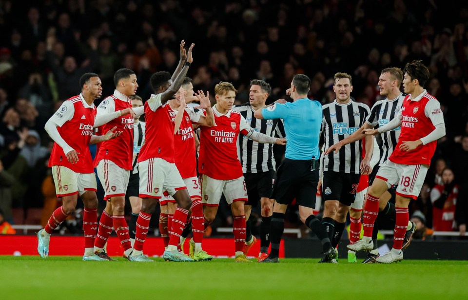 Arsenal's players furiously appeal for a late penalty for a handball