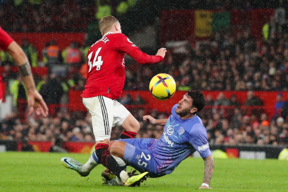 Donny van de Beek's knee bent awkwardly under a challenge from Marcos Senesi