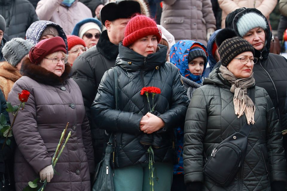 Mourners gather to lay flowers after the biggest single loss of life that Moscow has acknowledged in the war