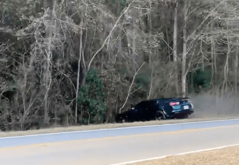 The Camaro driver spun 180 degrees and ended up in the trees