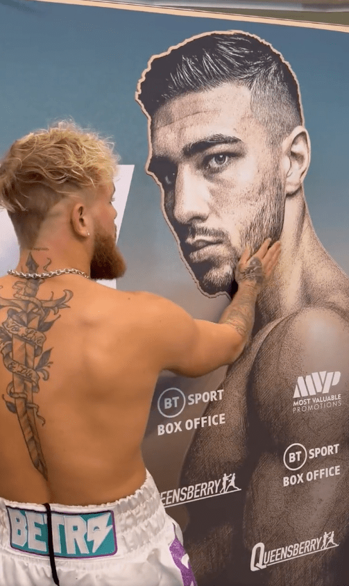 Jake Paul talking to a poster of Tommy Fury