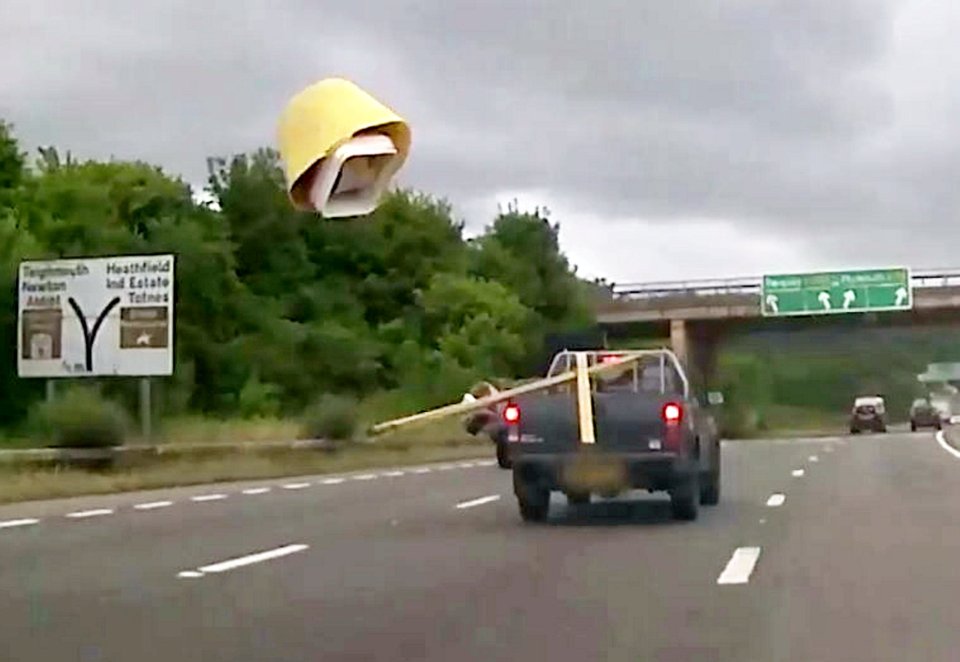 The yellow bucket is seen  flying off the back of the truck