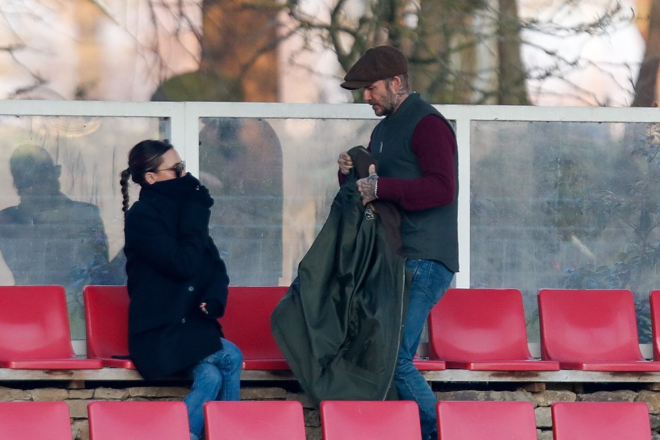 Becks gave wife Victoria his coat as they watched son Romeo in action for Brentford B