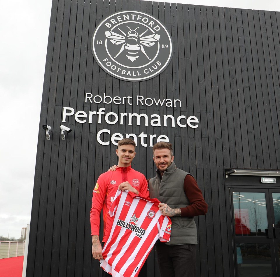 Romeo Beckham posed with David outside Brentford's performance centre