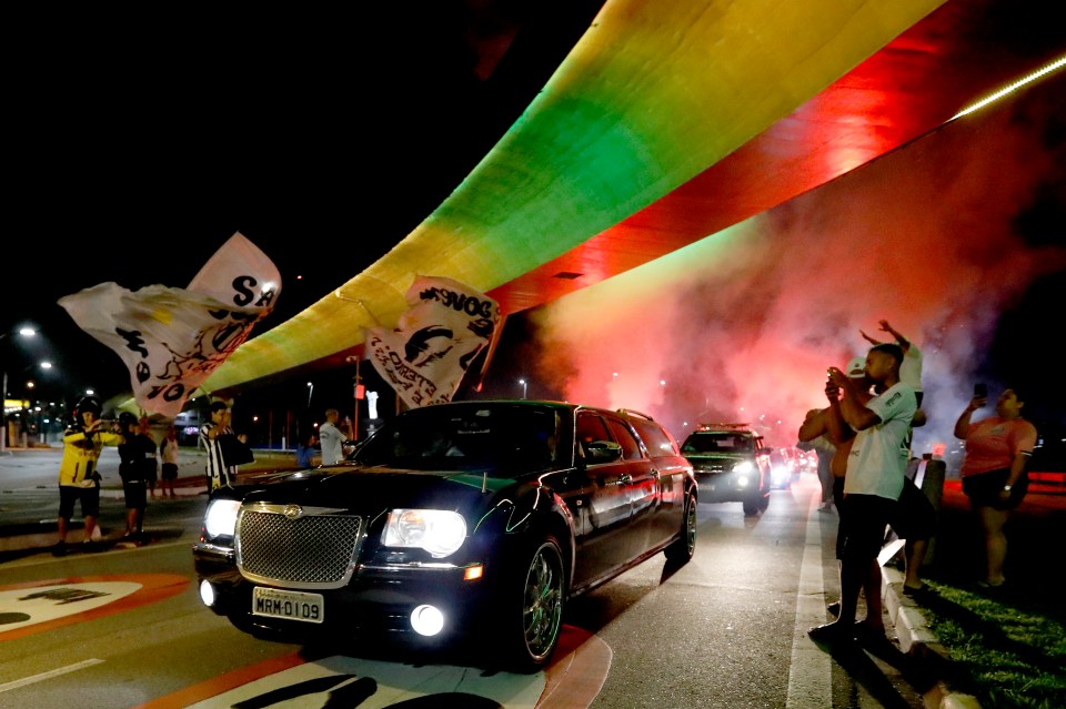 The hearse carrying Pele’s coffin arrives at Santos ahead of the football legend’s funeral in the stadium