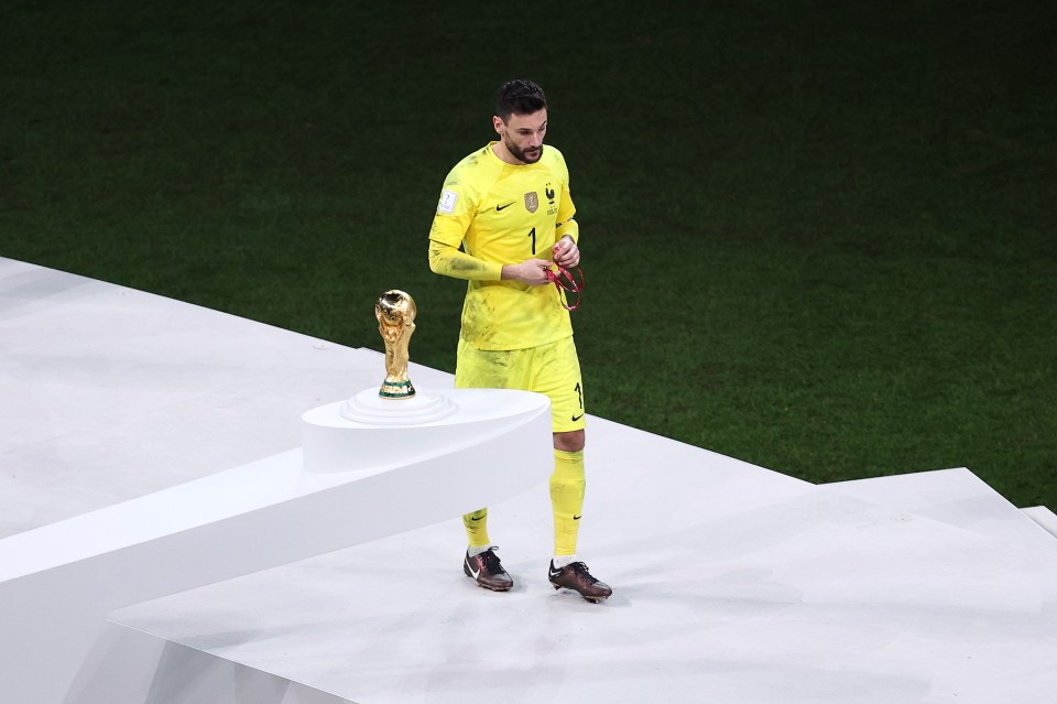 Lloris dejectedly walks past the World Cup trophy after France's final loss