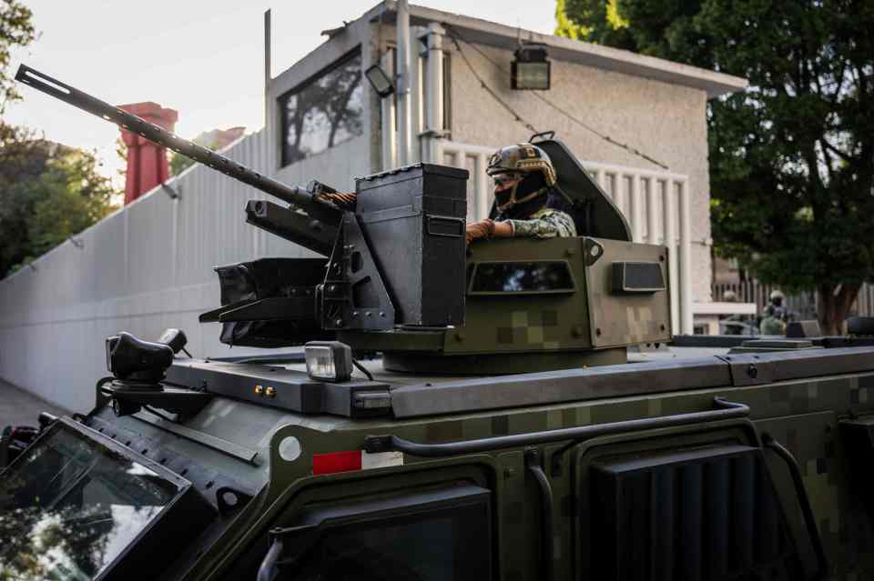 An armoured vehicle patrols after the arrest of the cartel boss