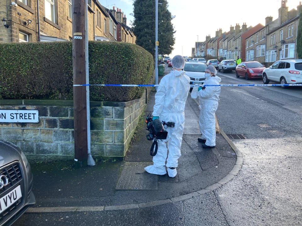 Forensics on the scene after a man, 33, was stabbed on a street in Huddersfield