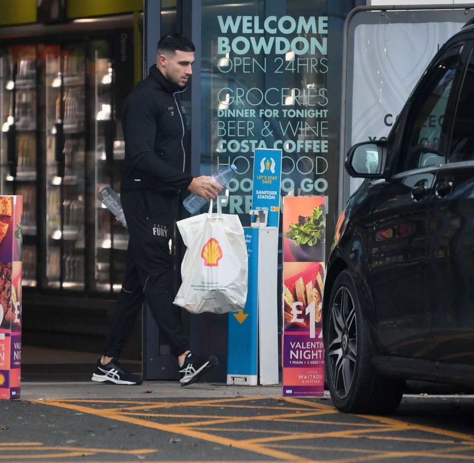 Tommy headed into a large people carrier after going shopping