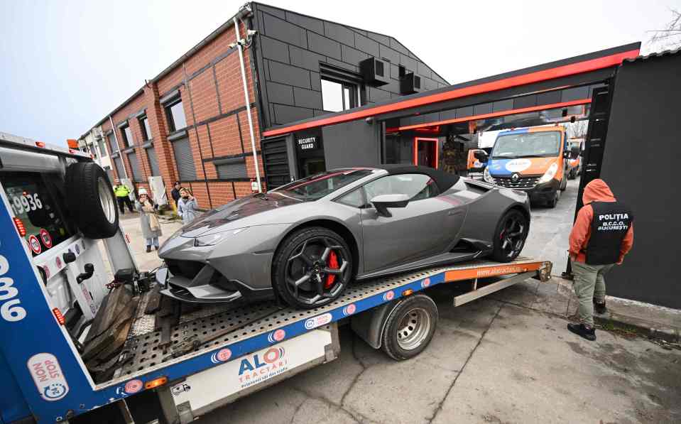 Police remove a Lamborghini from the Tate compound in Romania