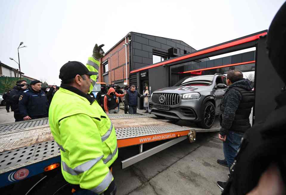 Police load up one of their Mercedes cars