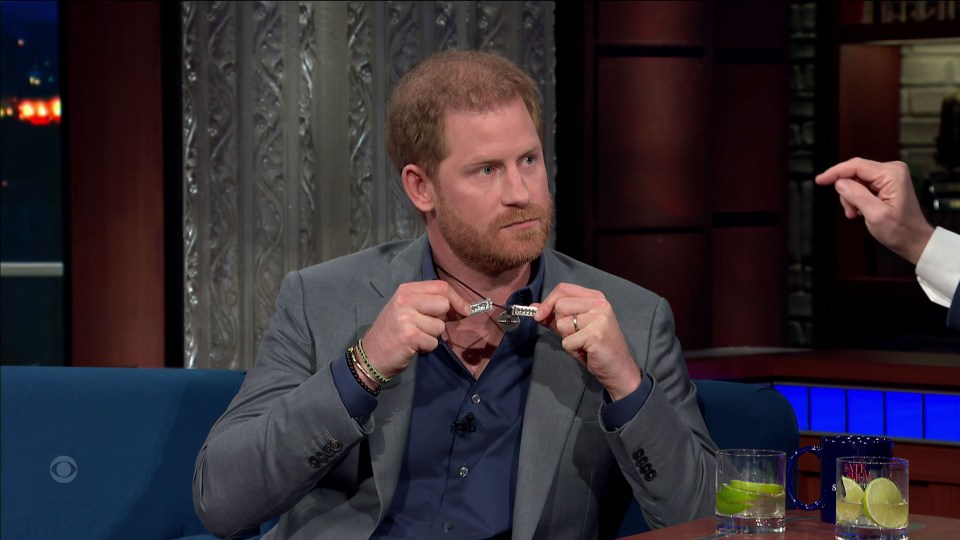 Prince Harry shows off his now repaired necklace during his appearance on The Late Show With Stephen Colbert