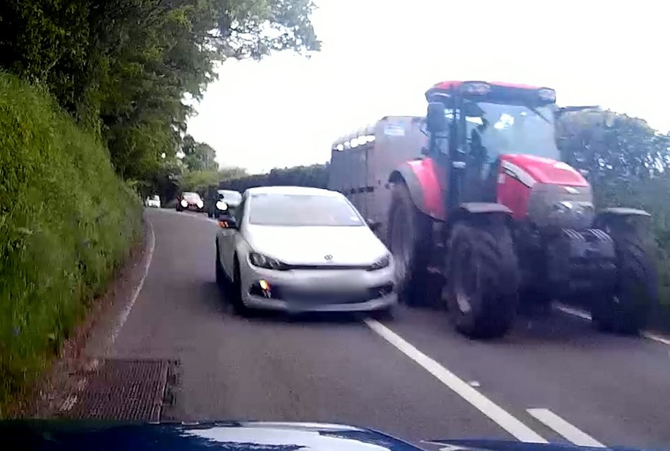 The driver of the white car was trying to overtake a tractor on a country lane