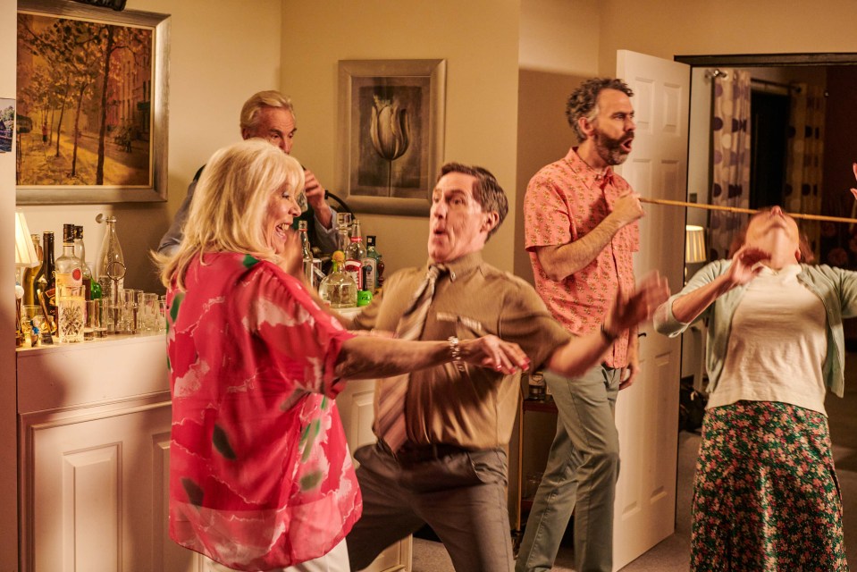 Still image from Gavin & Stacey: The Finale showing the main cast playing a party game.