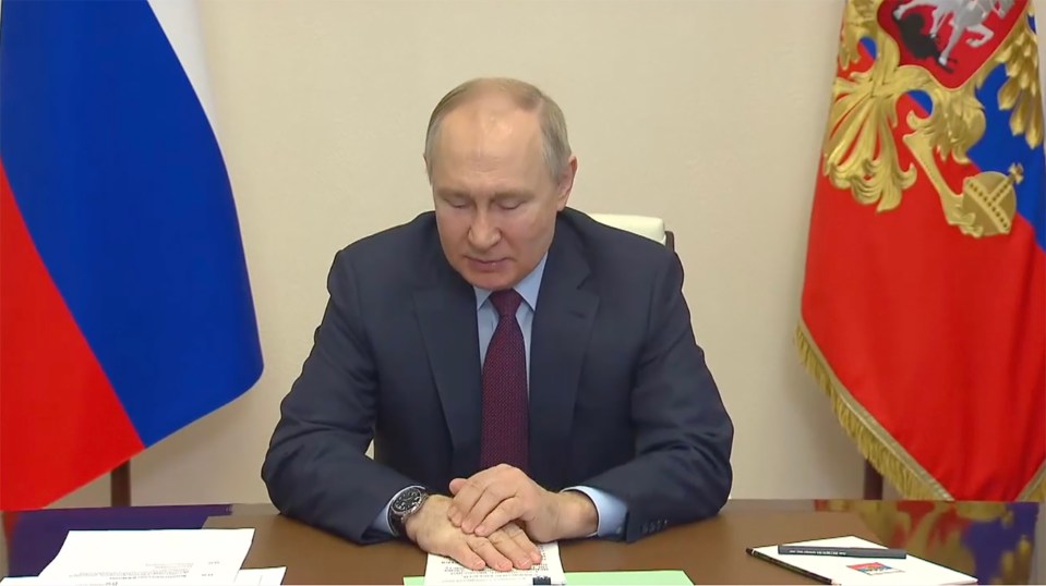 He appeared to massage his hand during the meeting