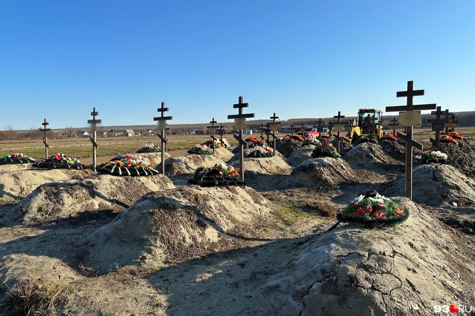 Flower wreaths and crosses adorn the graves of the criminal soldiers