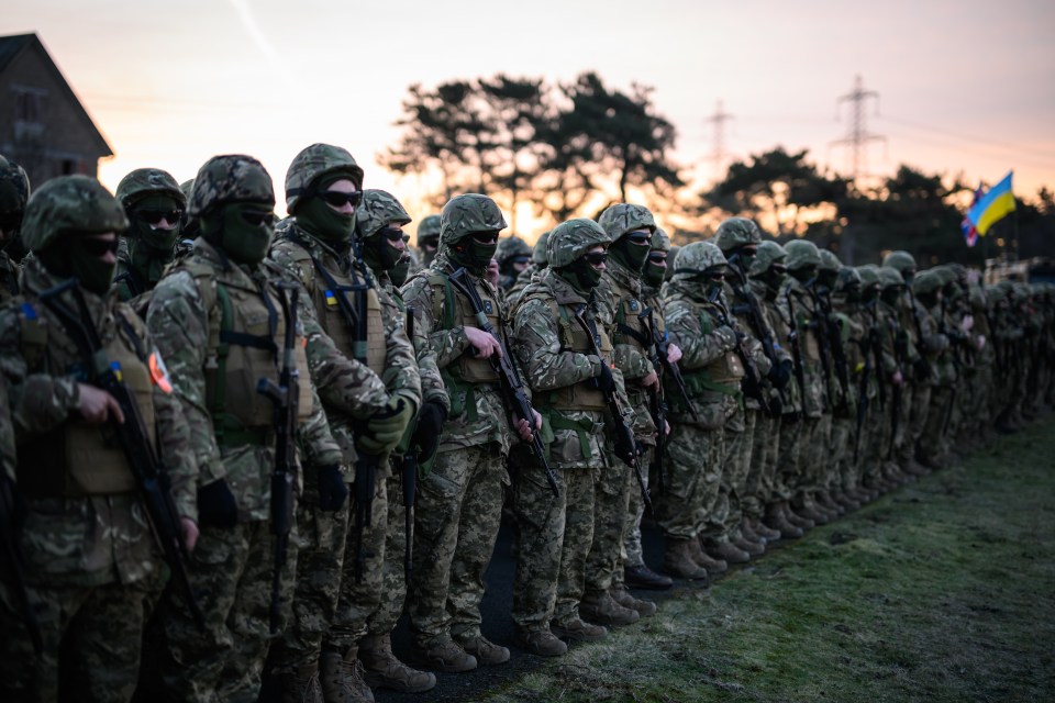 Ukrainian troops take part in a one minute silence at Lydd army camp in Kent