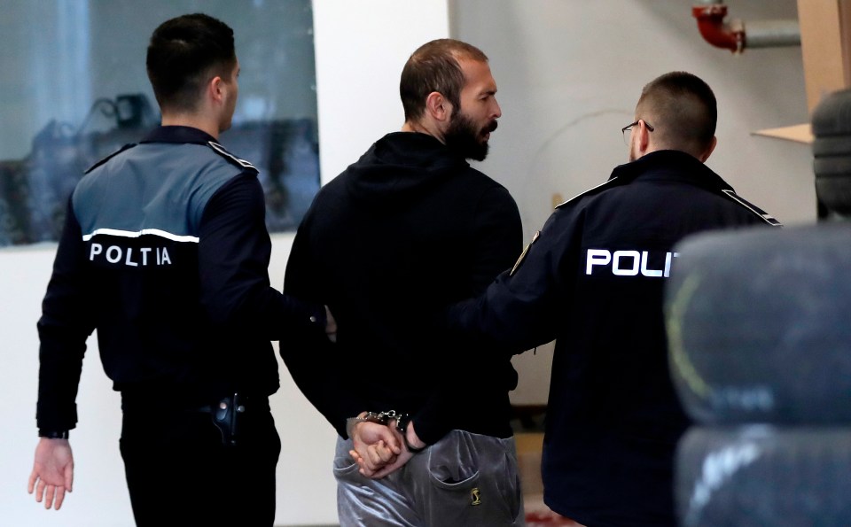 Andrew Tate is escorted by police officers to the DIICOT HQ in Bucharest