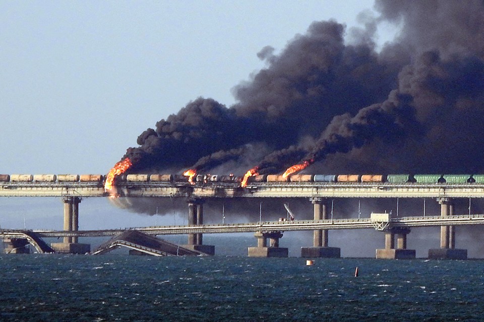 Black smoke billows from a fire on the bridge that links Crimea to Russia