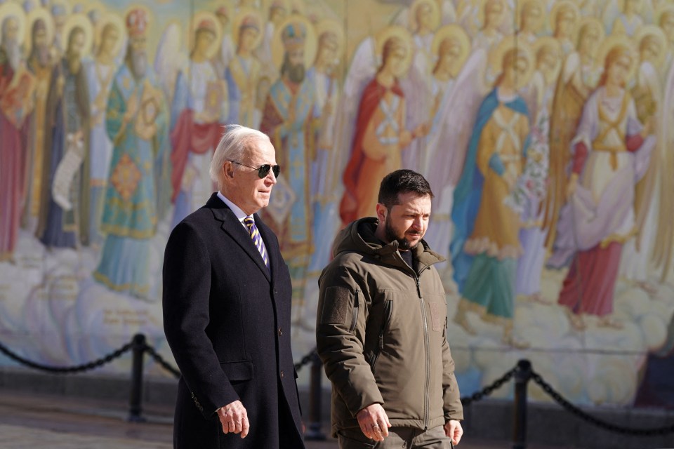 The duo walk in front of a mural of angels near St Michael’s Cathedral