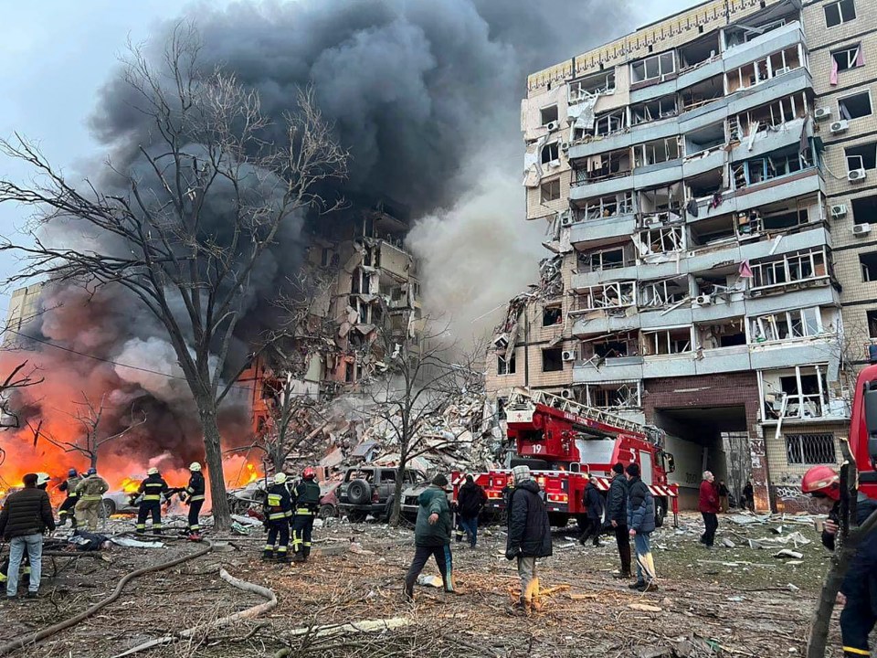 Ukrainian rescuers working at the site of a residential building hit by shelling in Dnipro