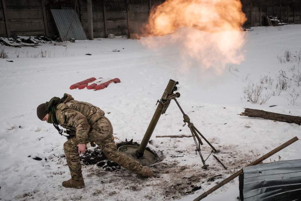 A Ukrainian serviceman fires a mortar toward the Russian position in Bakhmut