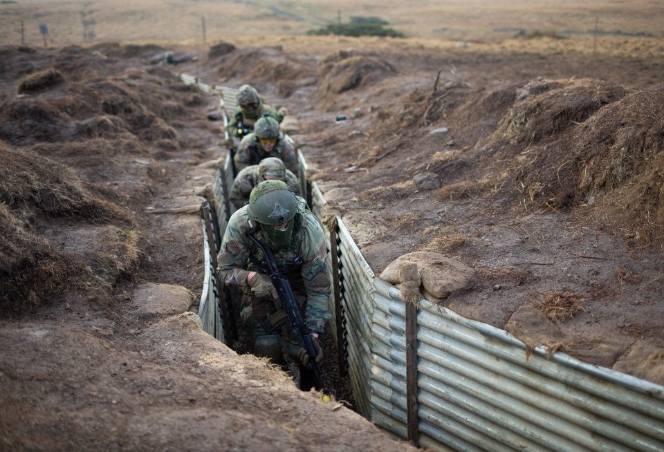 Ukrainian military personnel undergo combat training in a trench in the UK