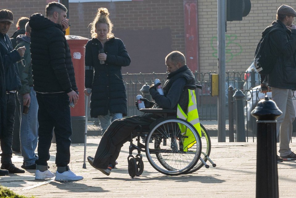 A group of people drinking cans on the corner of Streetly Road near Slade Road