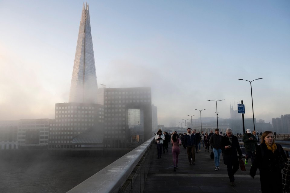 London Bridge in the fog as commuters arrive for work in the City of London