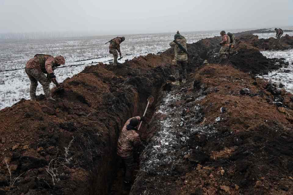 Ukrainian troops dig a trench near Bakhmut