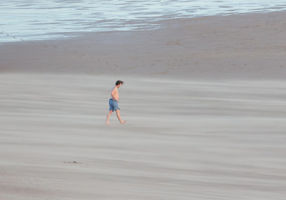 A brave swimmer takes a dip despite the wild weather on Tynemouth Beach, North Tyneside, this morning