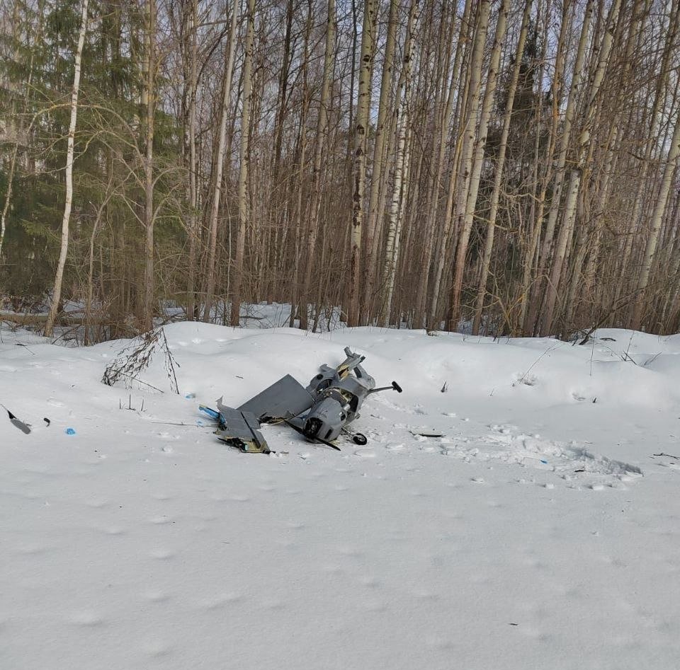 Wreckage of the drone can be seen on the snowy terrain