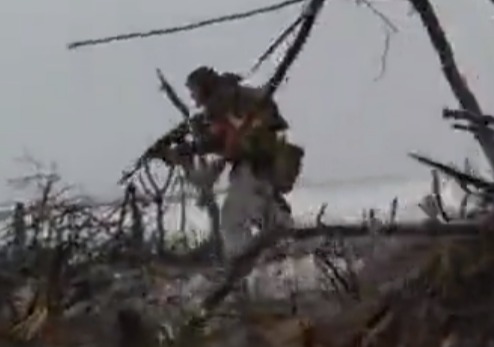 Unaware of the Ukrainian presence, the Wagner Group attacker menacingly zeroes his gun downwards on a trench