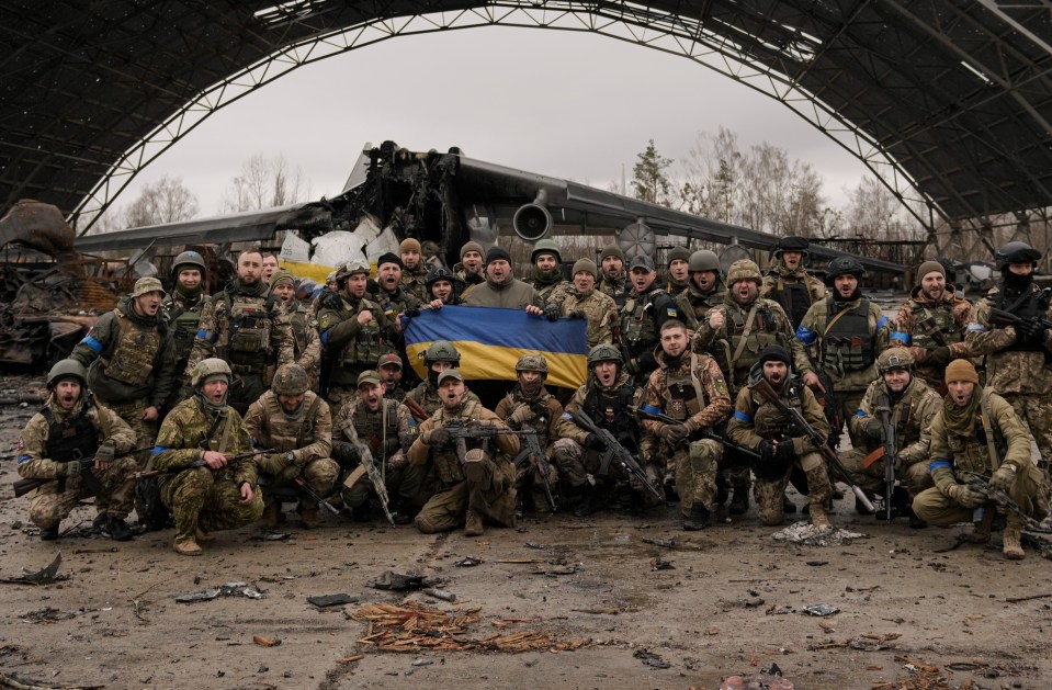 Ukrainian soldiers celebrate the recapture of Hostomel Airport