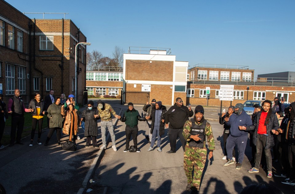 Parents have gathered in protest after an alleged racist attack at a school in Surrey on January 6