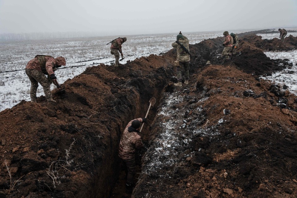 Outside the city, Ukrainian servicemen dig trenches in Bakhmut’s frozen ground