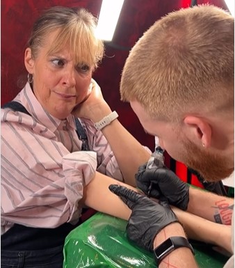 Mel Giedroyc looks nervous as Strictly pro Neil Jones tattoos her arm