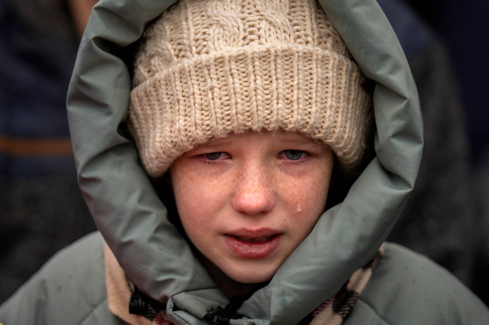 Anna cries next to the body of her brother Yurii, 27, during his funeral near Kyiv