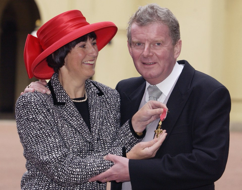 Getting his MBE with wife Anne who helped him collate information on players and games