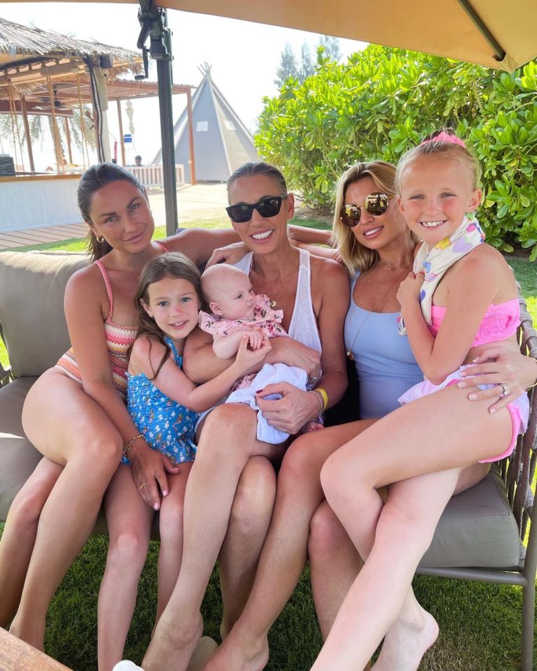 Sam cosies up to her daughter Rosie, her mum Suzie, sister Billie and her two children