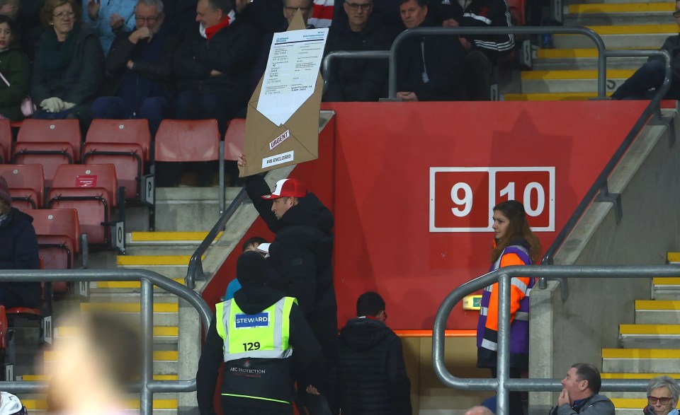 The fan was escorted out for the anti Jones sign