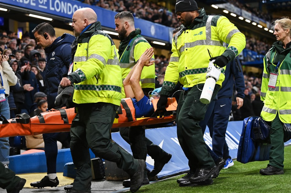 Ambulance staff carried the Spaniard away as he applauded the fans