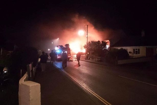 Flames ripped through a car and shop in a village made famous by Doc Martin