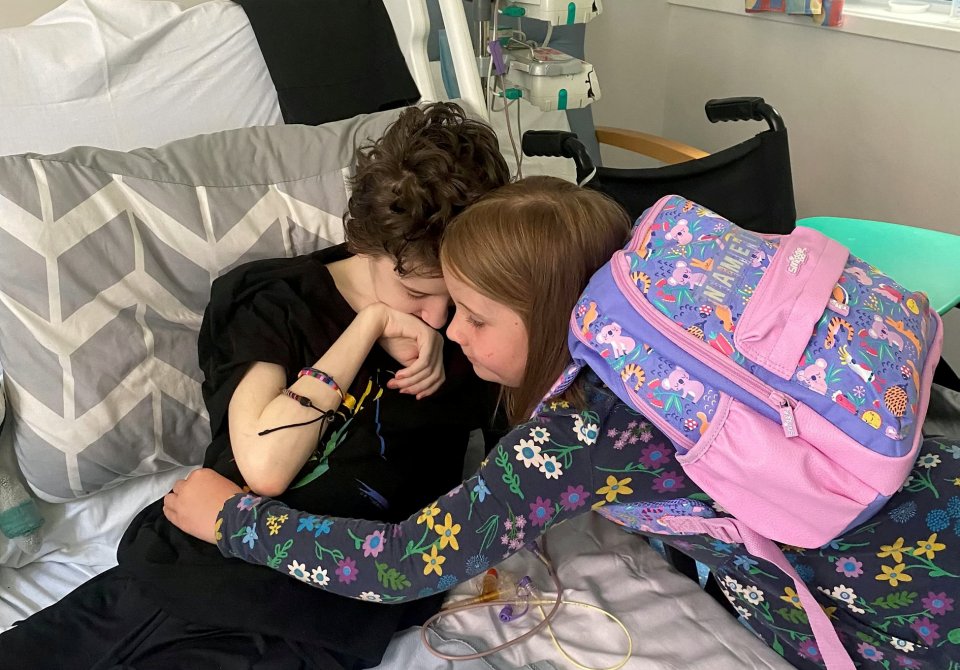 He became so unwell doctors were forced to perform an operation to have a feeding tube permanently placed in the stomach in order to feed him. Pictured: Alfie is hugged by his sister