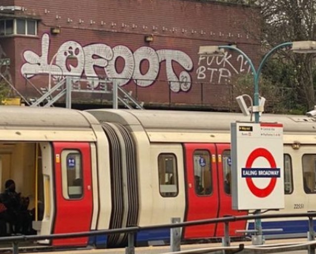 Graffiti sprayer 10 Foot’s scrawl at Ealing Broadway tube station in London