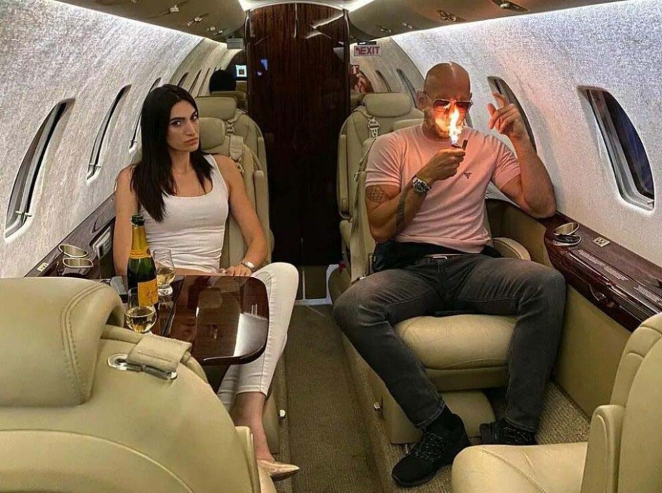 Georgiana Naghel and Tate on a private jet as he lights up a cigar