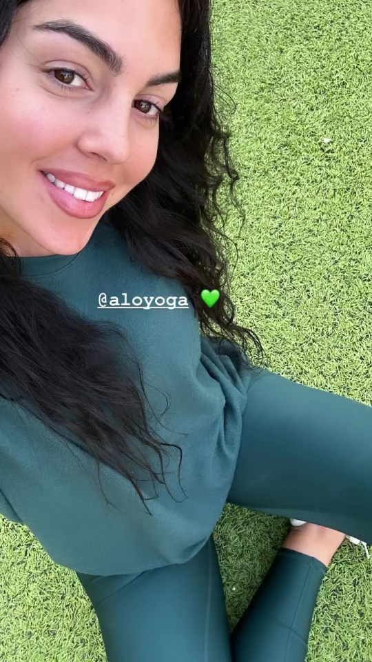 Georgina posed in all green yoga gear