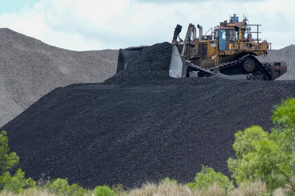 Heavy machinery shifting coal at an Australian mine