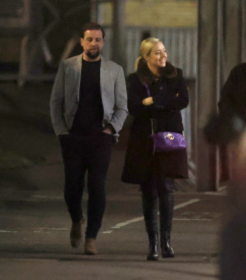 Kelsey wrapped up warm in a smart black coat with faux fur trim alongside her new man